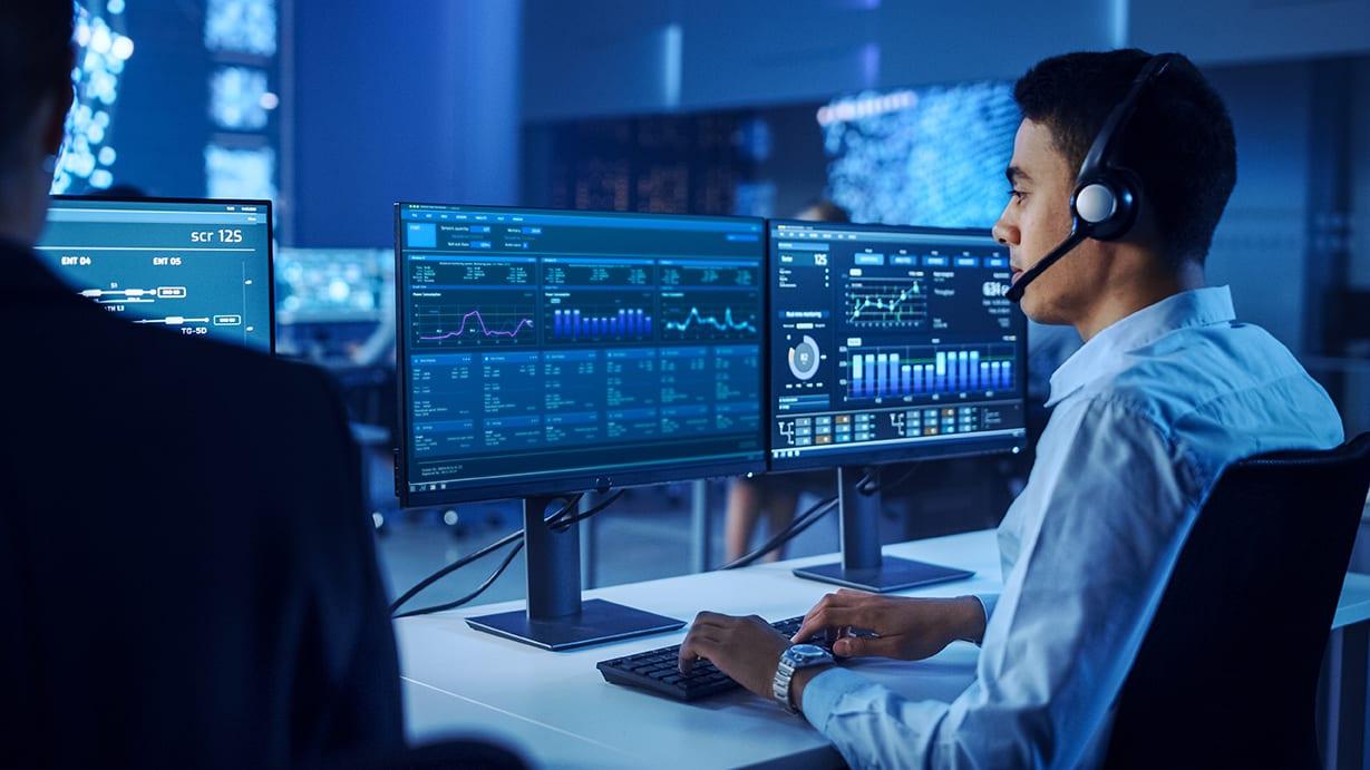 IT team monitoring network systems and servers using proactive monitoring solutions in a control room